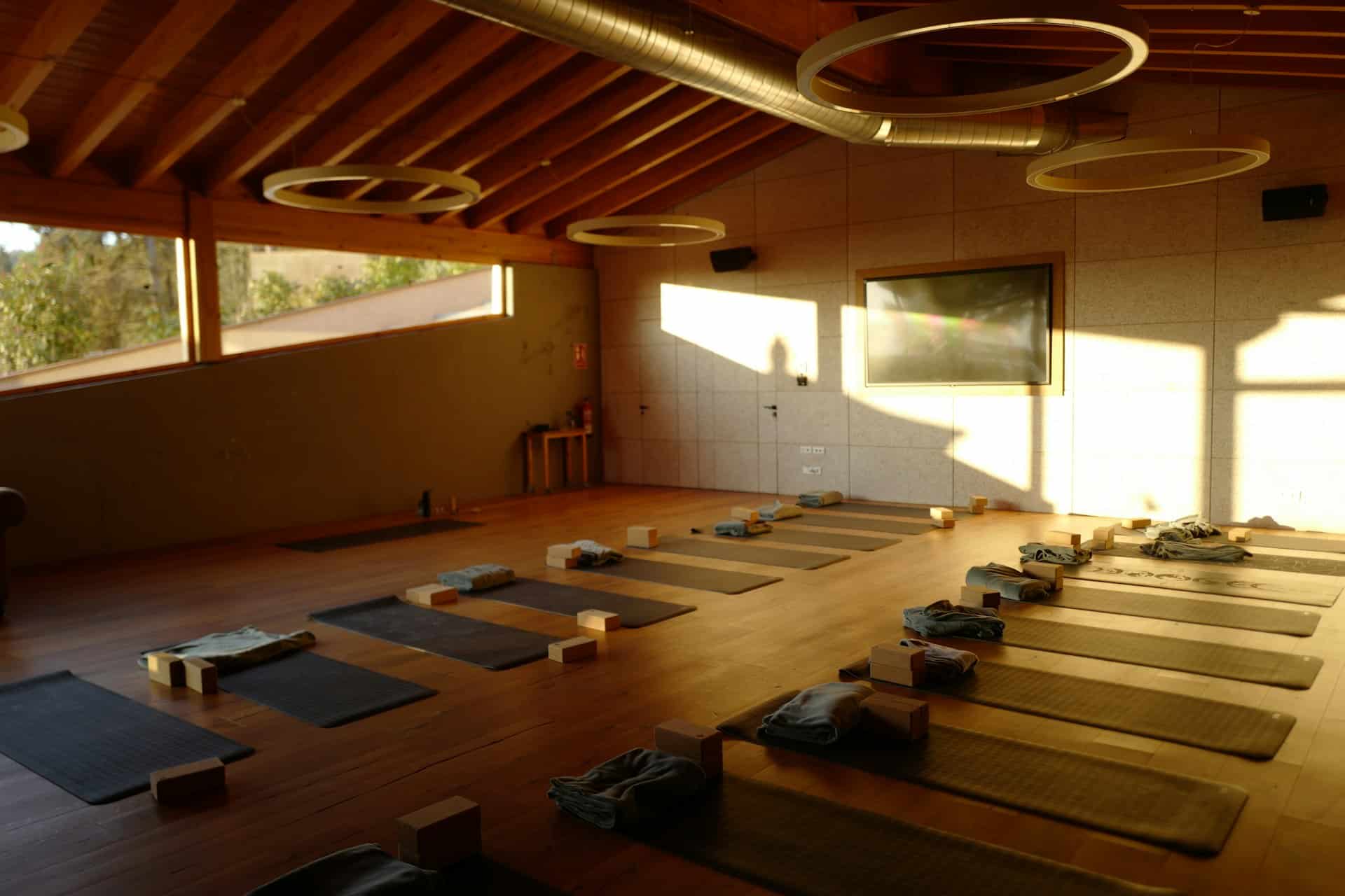 Salle de pratique de yoga avec tapis disposés au sol